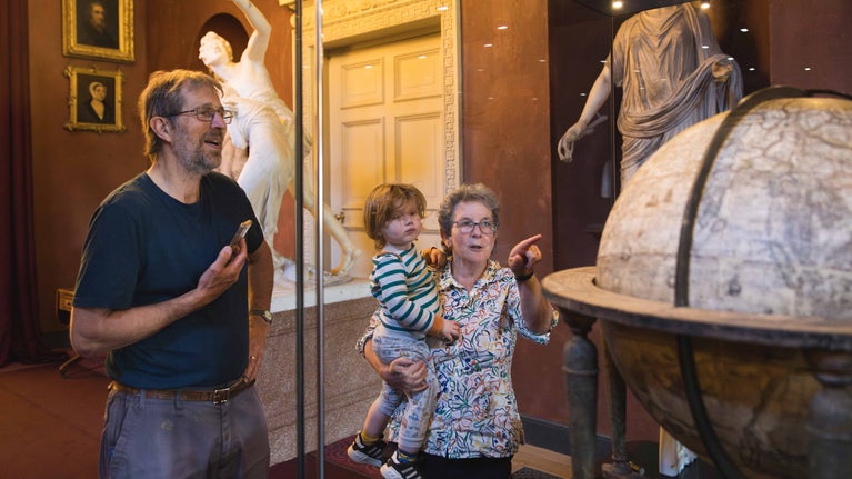 Visitors viewing the Molyneux Globe in the North Gallery at Petworth